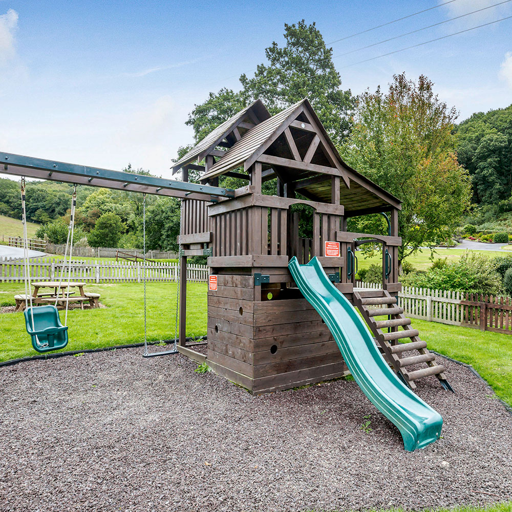 childrens play area with swings and slides