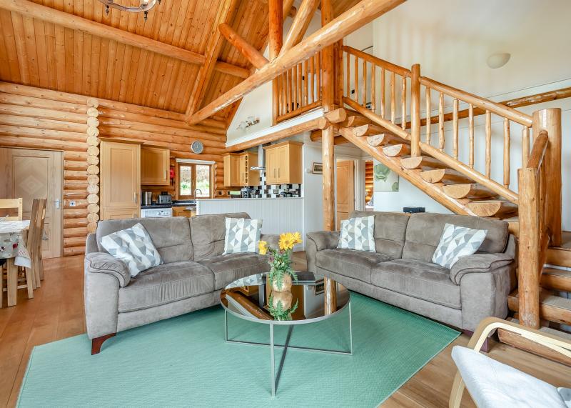 Living area showing beautiful log staircase