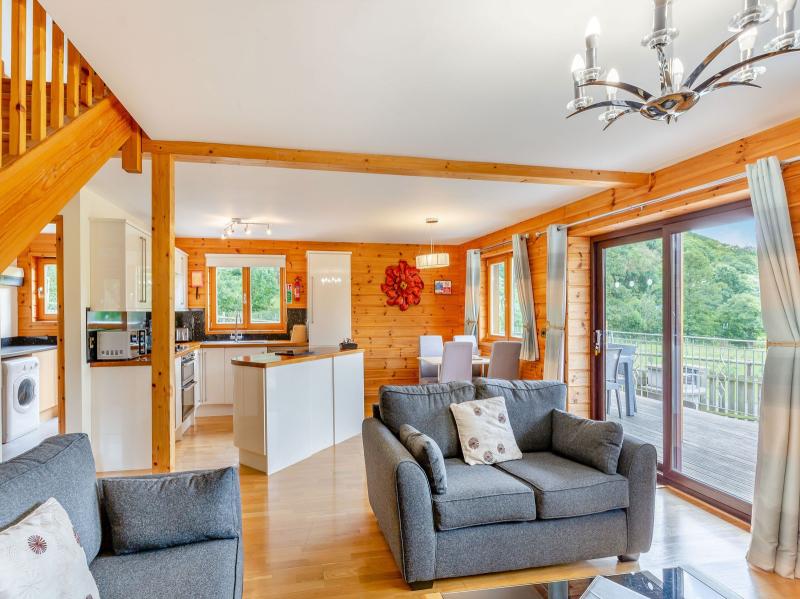 Living area showing open plan fully equipped kitchen