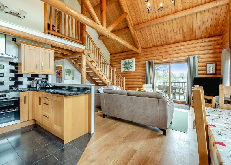 Open plan kitchen / dining area with spacious high ceiling