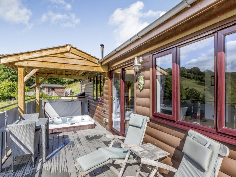 Private sunken hot tub with outside dining/seating area