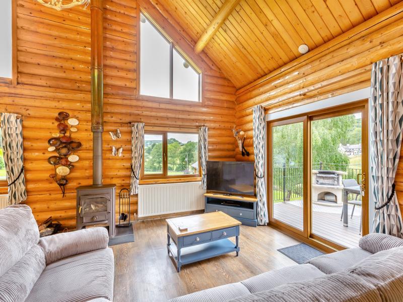 Living area showing entrance to the private outside area and wood burner